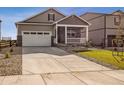 Two-story home with front porch and attached garage, newly built at 18359 Field Mint Pt, Parker, CO 80134