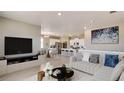 Open concept living area with kitchen and breakfast bar visible at 18359 Field Mint Pt, Parker, CO 80134