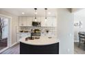 Lovely remodeled kitchen features white cabinetry, stainless appliances, quartz counters, and stylish backsplash at 909 Reynolds Farm Ln # C2, Longmont, CO 80503