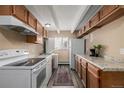 Galley kitchen featuring wood cabinets, granite countertops, updated appliances, and natural light at 1180 Yosemite St # 104, Denver, CO 80220