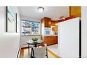 Cozy kitchen features wood cabinets and a dining area at 1056 N Marion St # 204, Denver, CO 80218