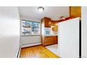 Efficient kitchen with wood cabinets and built-in appliances at 1056 N Marion St # 204, Denver, CO 80218