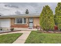 Charming brick home featuring well-manicured lawn and mature landscaping at 3751 W 85Th Ave, Westminster, CO 80031