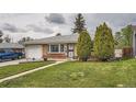 Beautiful home showcasing a well-kept lawn, brick facade, and neatly trimmed evergreen trees at 3751 W 85Th Ave, Westminster, CO 80031