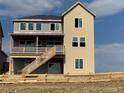 Exterior of two-story home with walkout basement; features upper and lower decks and backyard at 9334 Quartz St, Arvada, CO 80007