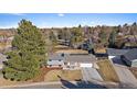 Aerial view of a single-Gathering home with mature trees, landscaping, and a two-car garage at 7110 S Cherry Dr, Centennial, CO 80122