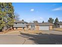 Charming brick home with a well-manicured front yard and an attached two-car garage at 7110 S Cherry Dr, Centennial, CO 80122