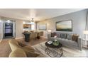 Cozy living room with dining area, neutral paint, stylish furniture and decor creating a modern yet comfortable space at 6410 S Dayton St # I05, Englewood, CO 80111