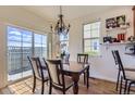 Inviting dining room with a chandelier, a table set for four, and sliding glass doors at 3752 Red Deer Trl, Broomfield, CO 80020