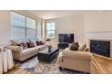 Bright living room features a fireplace, neutral walls and carpeting, and a large window for natural light at 3752 Red Deer Trl, Broomfield, CO 80020