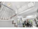 Bright foyer with high ceilings, white railing staircase and chandelier at 5997 S Yakima St, Aurora, CO 80015