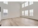 Spacious living room featuring wood floors, high ceilings, and lots of natural light from large windows at 39460 Congress Ln, Elizabeth, CO 80107