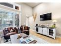 Bright living area featuring large windows, hardwood floors, and a sleek entertainment center, perfect for relaxing at 200 Primrose Path # 11, Breckenridge, CO 80424