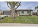 Street view of a single-Gathering home with an attached garage and mature front yard tree at 5925 W 86Th Ave, Arvada, CO 80003
