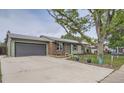 Quaint home featuring a convenient attached garage and a spacious concrete driveway at 5925 W 86Th Ave, Arvada, CO 80003