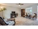 Comfortable living room with neutral walls, plush carpet, ceiling fan, and ample seating at 5925 W 86Th Ave, Arvada, CO 80003