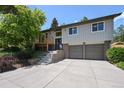 Inviting two-story home with a charming front yard, beautiful landscaping and a two-car garage at 1073 Xenon St, Golden, CO 80401