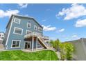 Lovely backyard featuring a spacious deck with stairs leading down to a well-manicured lawn at 900 Eldorado Ln, Louisville, CO 80027