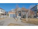 A well-maintained single Gathering home with a gray garage door and neat front yard at 1392 S Duquesne Cir, Aurora, CO 80018