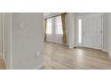 Bright entryway featuring sleek floors, white trim, and modern front door at 23895 E Rocky Top Pl, Aurora, CO 80016