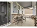 Inviting front porch with decorative stone accents and cozy seating area at 23895 E Rocky Top Pl, Aurora, CO 80016
