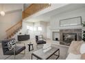 Open living room showcasing a fireplace and high ceilings at 9877 Grove St # C, Westminster, CO 80031