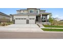 Charming two-story home with a three-car garage, well-maintained lawn, and inviting porch at 23814 E 36Th Pl, Aurora, CO 80019