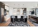 Bright eat-in kitchen featuring a large island with bar seating and modern appliances at 23814 E 36Th Pl, Aurora, CO 80019