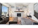 Inviting living room with fireplace, large windows, and modern decor at 23814 E 36Th Pl, Aurora, CO 80019