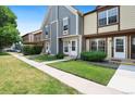 Attractive townhome featuring a well-maintained lawn and welcoming walkway at 14485 E Hawaii Cir # B, Aurora, CO 80012