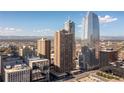 Stunning exterior showcasing high-rise building with city skyline and mountain view at 1020 15Th St # 15K, Denver, CO 80202