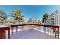 Spacious deck featuring stained wood railings and ample space for relaxing and entertaining outdoors at 5421 E Prescott Ave, Castle Rock, CO 80104