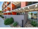 Street view of the modern building exterior with visible architectural details and a well-maintained landscape at 1495 Vrain St # 110, Denver, CO 80204