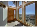 Bright foyer with tile flooring, large windows, and a beautiful mountain view at 1295 Hy Vu Dr, Evergreen, CO 80439