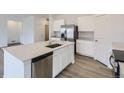 Modern kitchen with stainless steel appliances, quartz counters and a large island at 15274 Milwaukee St, Thornton, CO 80602