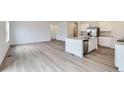 Spacious open-concept living area featuring hardwood floors and a modern kitchen at 15274 Milwaukee St, Thornton, CO 80602