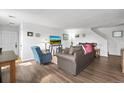 Cozy living room with laminate flooring, neutral walls, and comfortable furnishings at 892 Macaw St, Brighton, CO 80601