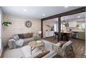 Open-concept living room with wood flooring, a comfortable seating arrangement, and a view into the kitchen at 4512 S Yank St, Morrison, CO 80465
