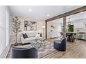 Inviting living room with stylish decor, a shiplap accent wall, and an open layout with hardwood flooring at 4512 S Yank St, Morrison, CO 80465