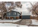 Charming two-story home featuring a brick facade and a well-maintained yard, complete with an attached two-car garage at 6280 S Colorado Blvd, Centennial, CO 80121