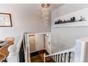 Stylish entryway showcasing modern chandelier, unique art, coat hooks, and sleek front door, offering a warm welcome at 6280 S Colorado Blvd, Centennial, CO 80121