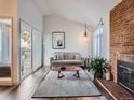 Open living room with hardwood floors, fireplace and neutral decor at 3351 S Monaco Pkwy # F, Denver, CO 80222