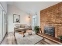 Living area features a fireplace and sliding glass doors to balcony at 3351 S Monaco Pkwy # F, Denver, CO 80222