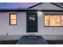 House exterior showcasing a green front door and light-colored siding at 401 S Oak St, Lakewood, CO 80226