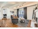 Bright living room with a slider to the balcony, stylish furniture, and modern lighting at 9995 E Harvard Ave # 224, Denver, CO 80231