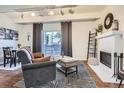 Inviting living room boasting a fireplace, balcony access, and contemporary decor at 9995 E Harvard Ave # 224, Denver, CO 80231