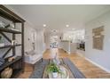 View of the living room featuring hardwood floors, neutral paint, and a view into the kitchen at 1705 W Stoll Pl, Denver, CO 80221