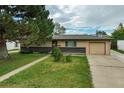Charming single-story home with an attached garage and mature tree in a well-maintained front yard at 1231 W Radcliff Ave, Englewood, CO 80110