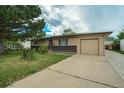 Charming single-story home with an attached garage and mature tree in a well-maintained front yard at 1231 W Radcliff Ave, Englewood, CO 80110