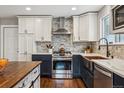 Modern kitchen with copper sink, stainless steel appliances, and custom island at 551 E Caley Dr, Centennial, CO 80121